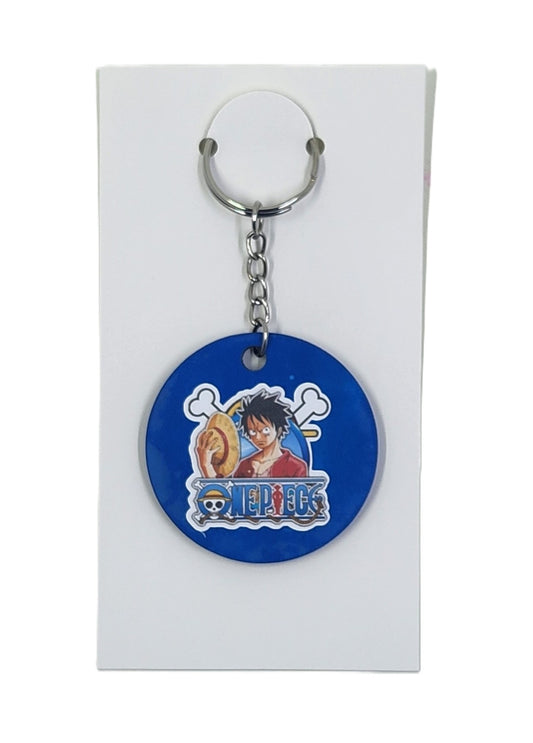 Keychain with 'One Piece' character design on a blue background, displayed on a white card.
