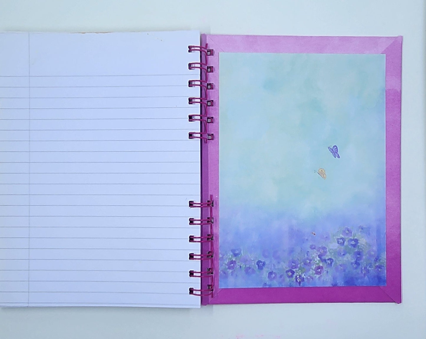 Notebook with a pink inside cover featuring floral design on a white background