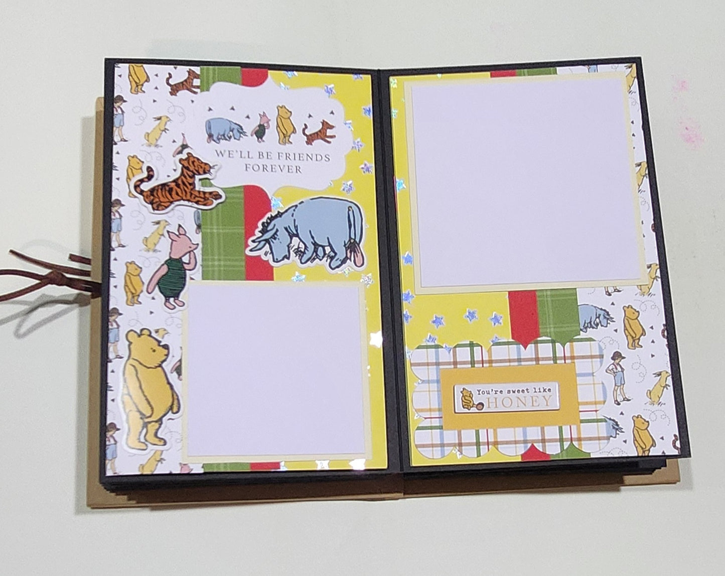 Open Photo Book with Winnie the Pooh illustrations on a white background