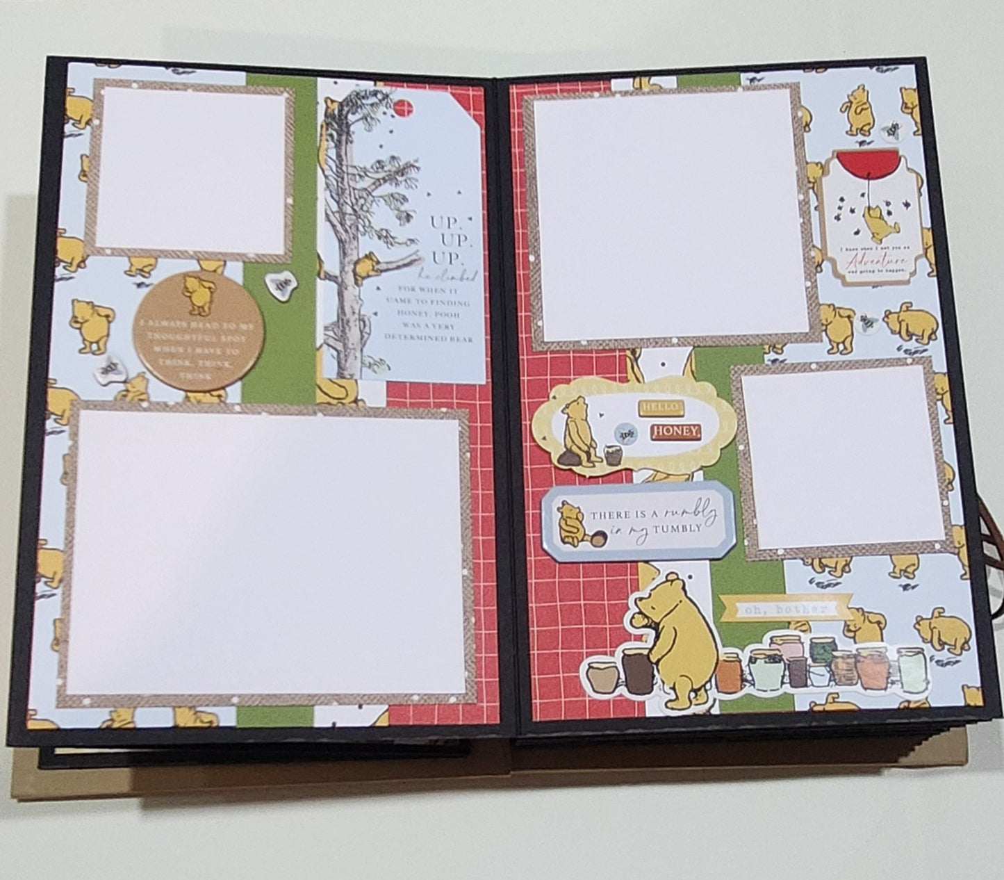 Scrapbook page with Winnie the Pooh design on a white background