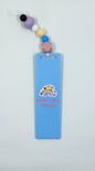 A blue acrylic bookmark with a rainbow design and Sanrio characters, complete with a cord and silicone beads in various colors.