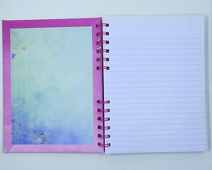Notebook with a colorful inside cover and lined pages on a white background