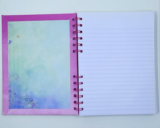 Notebook with a colorful inside cover and lined pages on a white background