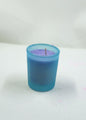 Blue candle with purple wax on a white background
