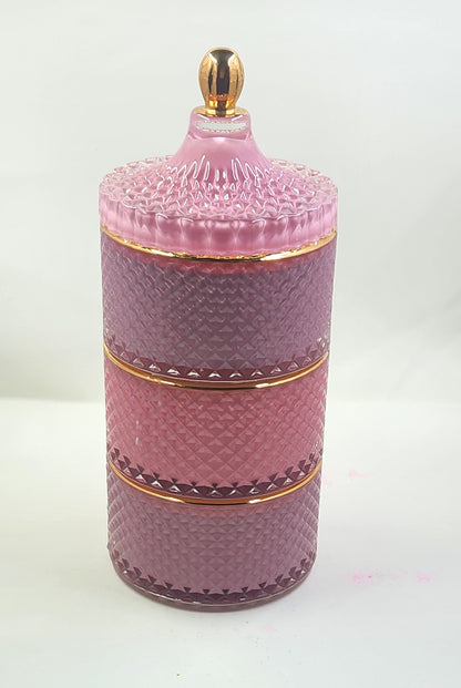 Pink textured cylindrical container with gold accents on a white background