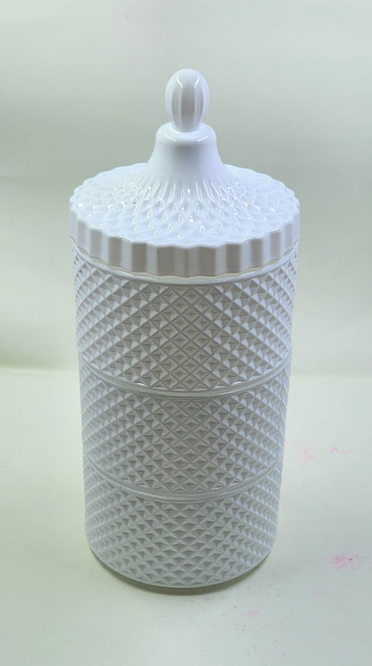 White textured jar with a lid on a light background