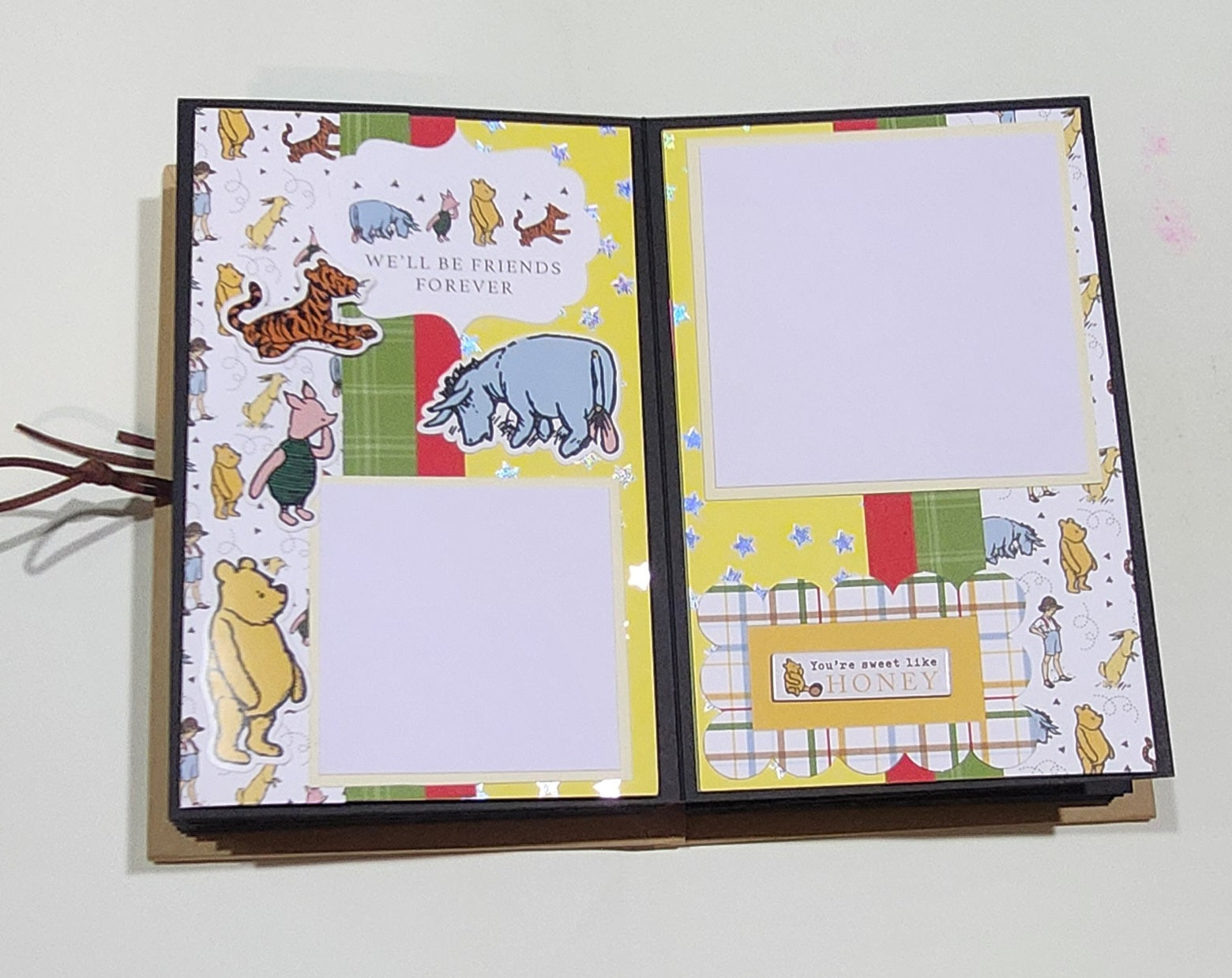 Open Photo Book with Winnie the Pooh illustrations on a white background